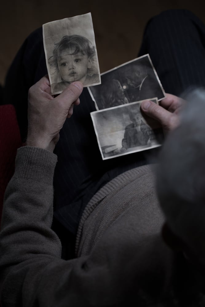 Top view to elder man watching his family pictures